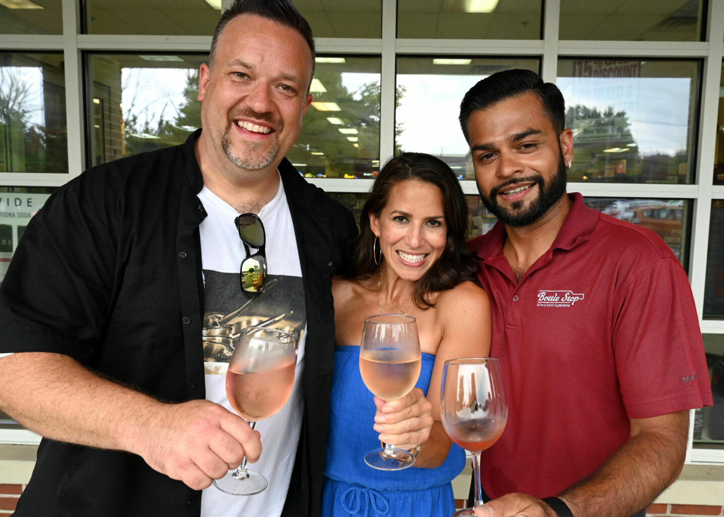 Chef Plum and Marysol Castro raise a glass of rosé with G. Patel, owner of Bottle Stop Wine & Spirits Superstore in Newtown. Photo: Ryan Caron King / Connecticut Public