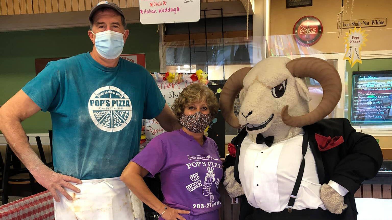 Pete DeBisschop, owner of Pop's Pizza in Cheshire, poses with his wife Chris and the Cheshire Ram. 
