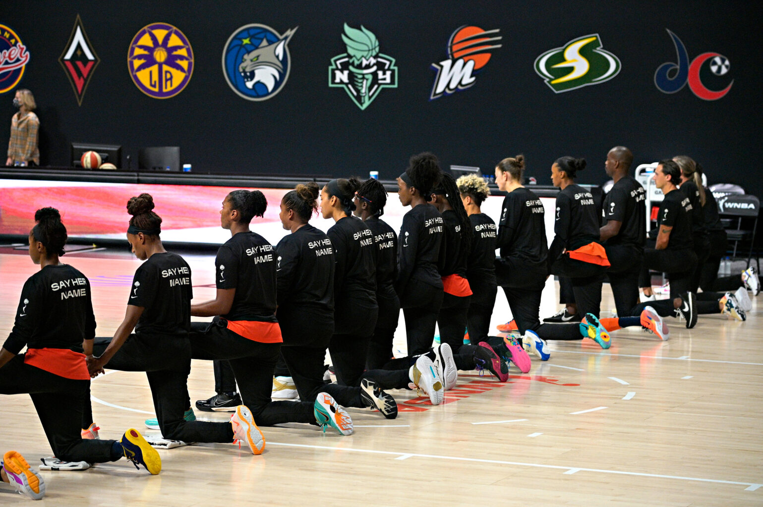 Members of the Connecticut Sun kneel during the playing of the national anthem before a WNBA basketball first round playoff game against the Chicago Sky, Tuesday, Sept. 15, 2020, in Bradenton, Fla. (AP Photo/Phelan M. Ebenhack)
