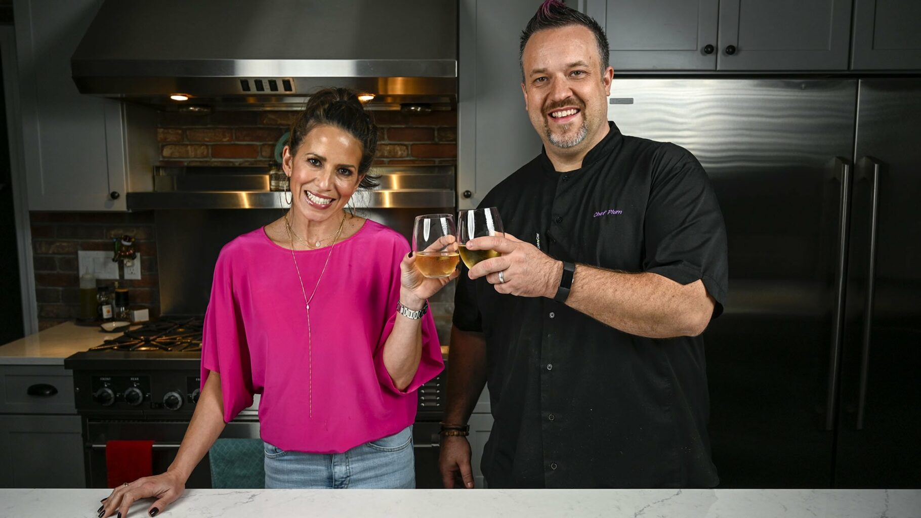 NEWTOWN, CT -  December 3, 2020: Production for Cutline Staying Connected Through Food with Marysol Castro and Chef Plum from Seasoned. Marysol and Chef pose for a Champagne toast. (Julianne Varacchi/Connecticut Public)