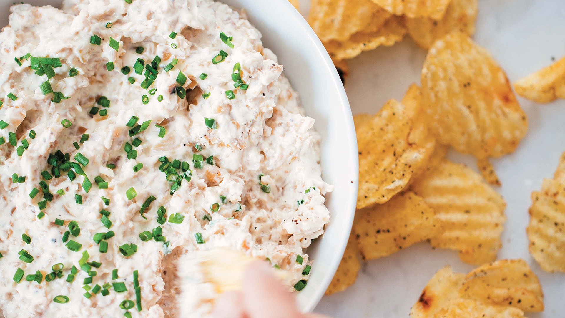 Four-Onion Dip recipe Excerpted from Onions Etcetera: The Essential Allium Cookbook by Kate Winslow and Guy Ambrosino. Copyright © 2017 by Kate Winslow and Guy Ambrosino. Published by Burgess Lea Press.