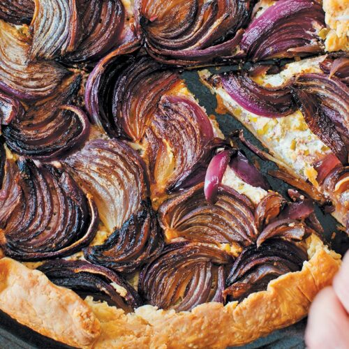 red onion goat cheese galette recipeExcerpted from Onions Etcetera: The Essential Allium Cookbook by Kate Winslow and Guy Ambrosino. Copyright © 2017 by Kate Winslow and Guy Ambrosino. Published by Burgess Lea Press.