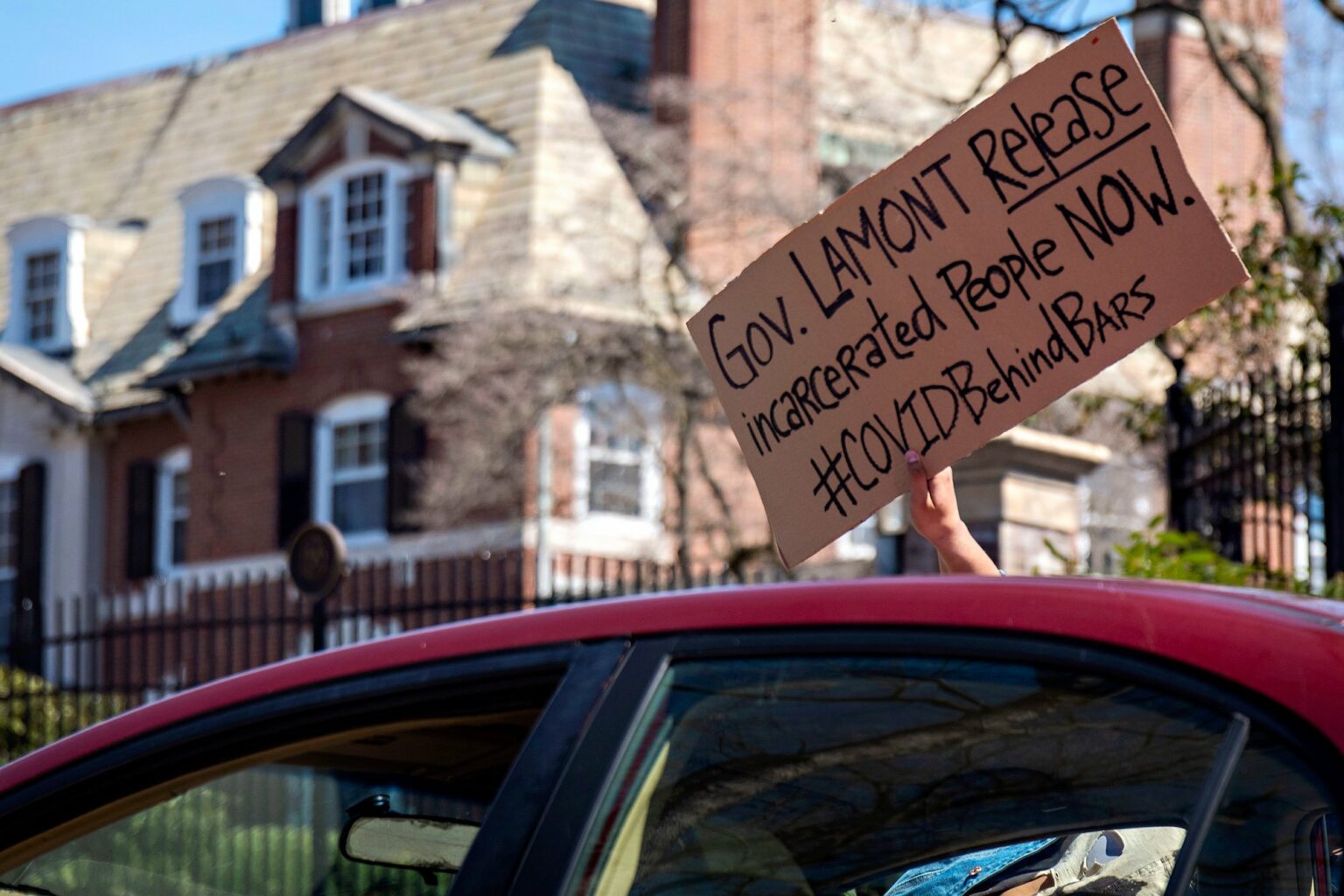 Cars lined up outside of the Connecticut Governor’s Residence in Hartford on Monday, April 6 in protest of Gov. Lamont’s refusal to release inmates at risk of COVID-19. Protesters remained in their cars honking and waving signs. Tyler Russell/Connecticut Public