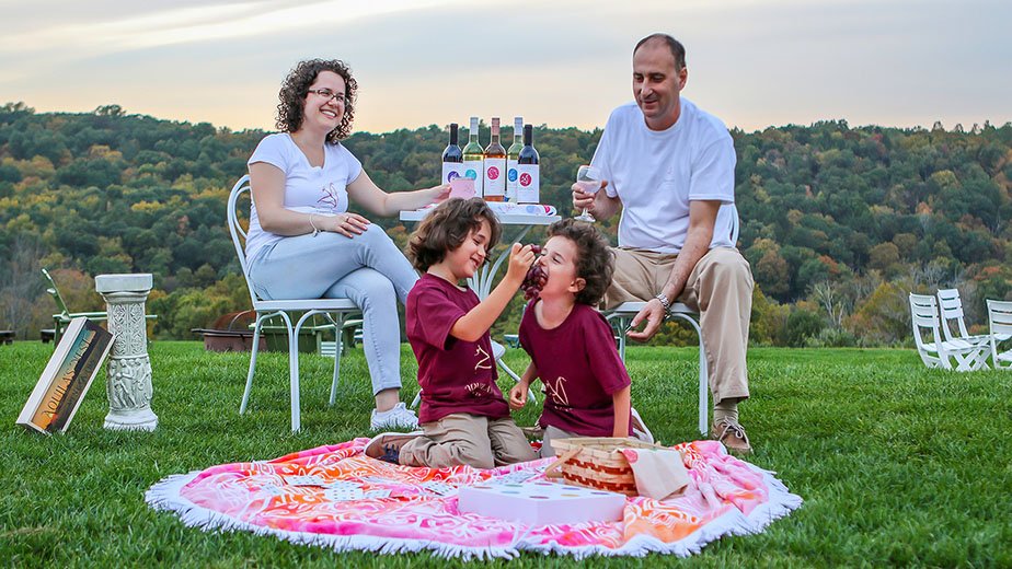 Neviana Zhgaba and Ardian Llomi with their children at Aquila's Nest Vineyard in Newtown, Conn.