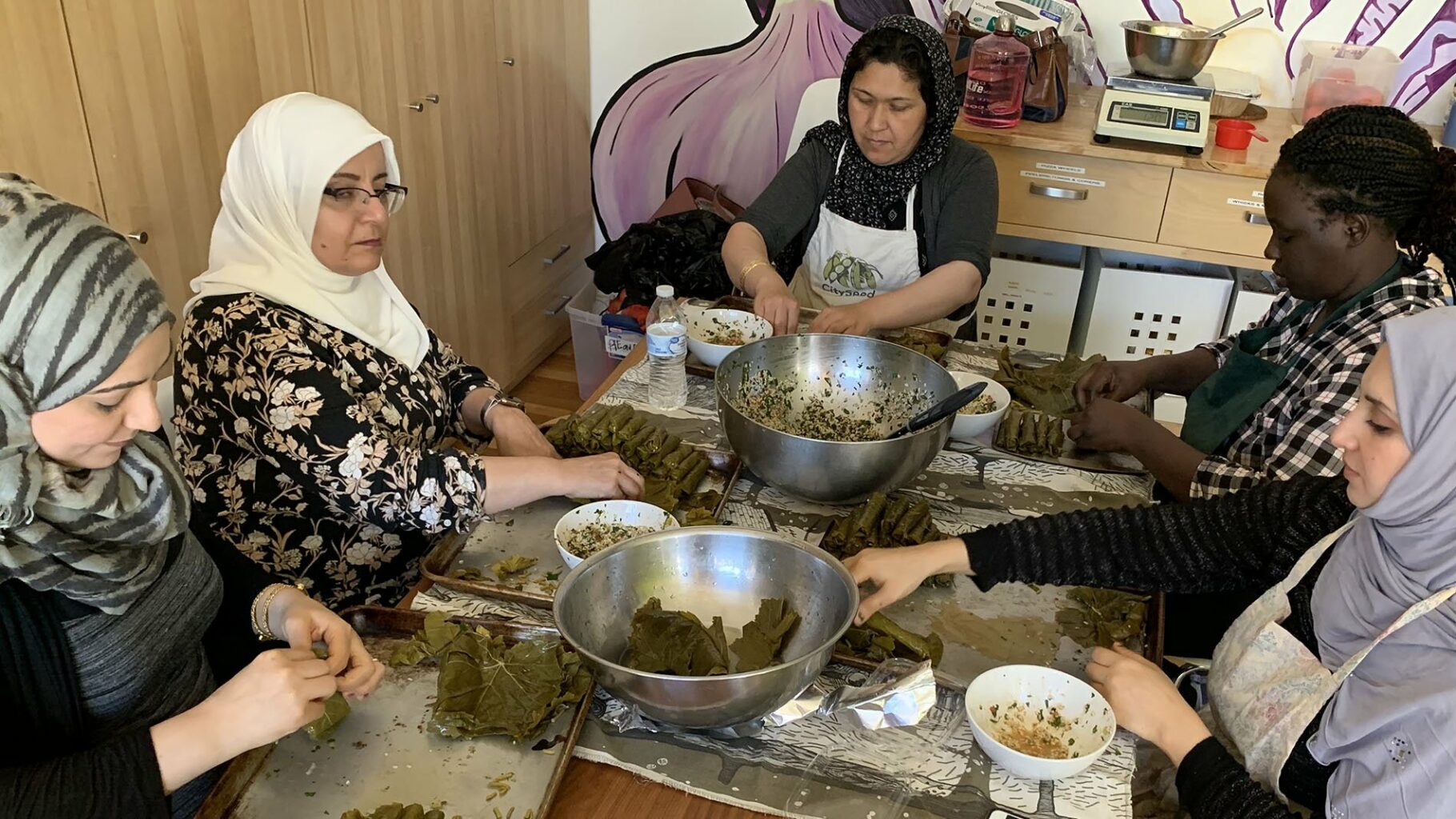 Syrian, Afghan, Sudanese, and Iraqi chefs at Sanctuary Kitchen making Syrian Yalenji