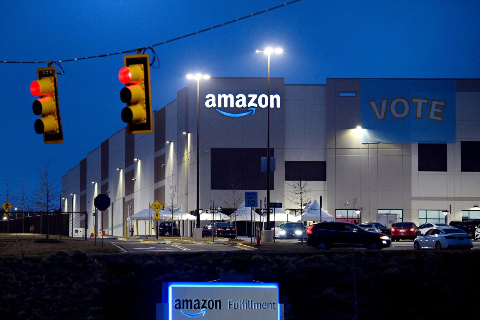 A Vote banner hangs at an Amazon fulfillment center early on March 27, 2021 in Bessemer, Alabama. - Amazon Alabama workers are trying to unionize with the Retail, Wholesale and Department Store Union (RWDSU) in Birmingham, as clashes intensified between lawmakers and the e-commerce giant ahead of a deadline for a vote that could lead to the first union on US soil at the massive tech company. The visit marks the latest high-profile appearance in the contentious organizing effort for some 5,800 employees at Amazon's warehouse in Bessemer which culminates next week.
Credit:  PATRICK T. FALLON/AFP/Getty Images