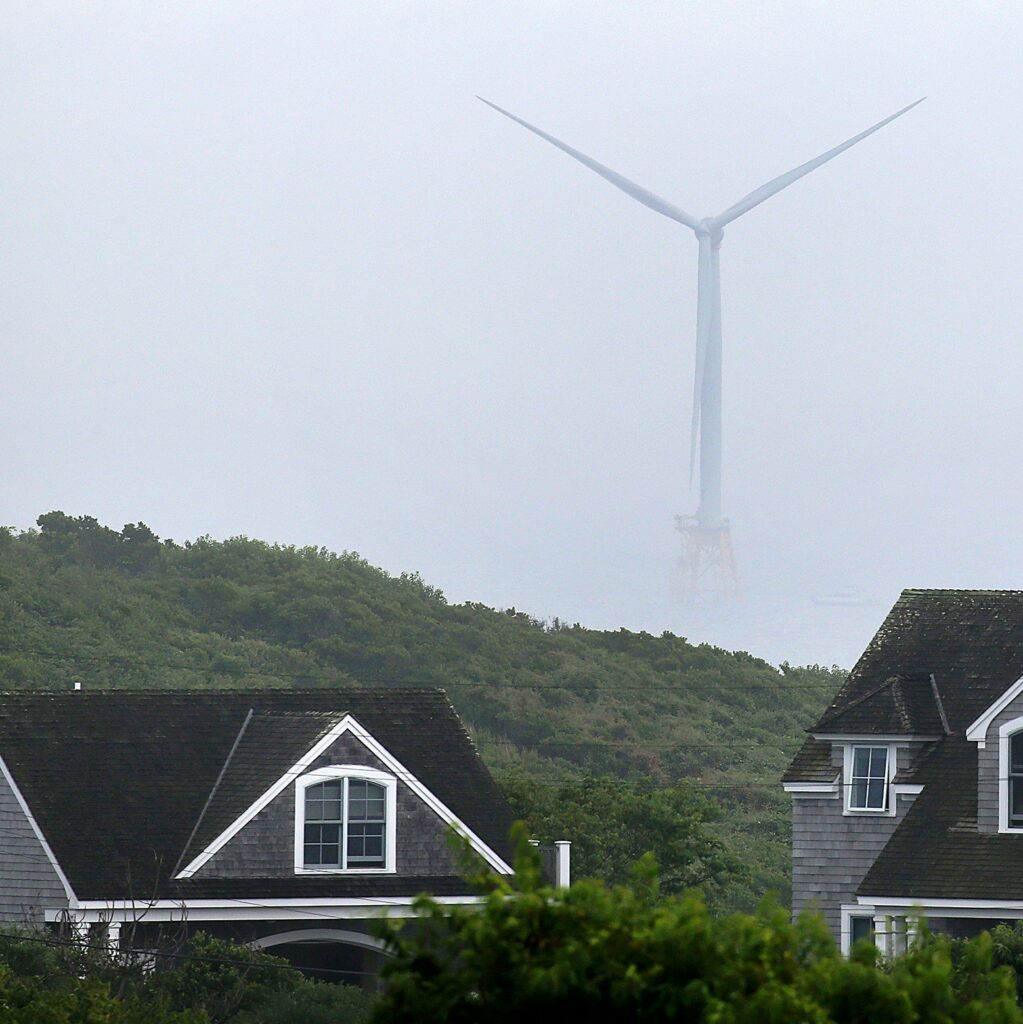 BLOCK ISLAND, RI - AUGUST 11: A offshore turbine is visible from Payne Road on Block Island, RI, Aug. 11, 2016.  Three miles off Block Island, the nation's first off-shore wind farm is nearing completion, a milestone that clean energy advocates hope will usher in a new era of wind power. (Photo by David L. Ryan/The Boston Globe via Getty Images)