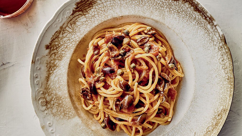 Spaghetti alla Puttanesca_recipe. Reprinted with permission from Pasta: The Spirit and Craft of Italy's Greatest Food by Missy Robbins and Talia Baiocchi, copyright © 2021. Published by Ten Speed Press, an imprint of Penguin Random House © 2021 by Kelly Puleio