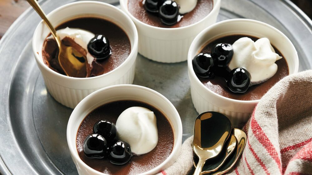 Chocolate Cardamom Pot de Creme recipe. Excerpted from Preppy Kitchen. Copyright © 2022, John Kanell. Photography Copyright © 2022 By David Malosh. Reproduced by permission of Simon Element, an imprint of Simon & Schuster. All rights reserved.