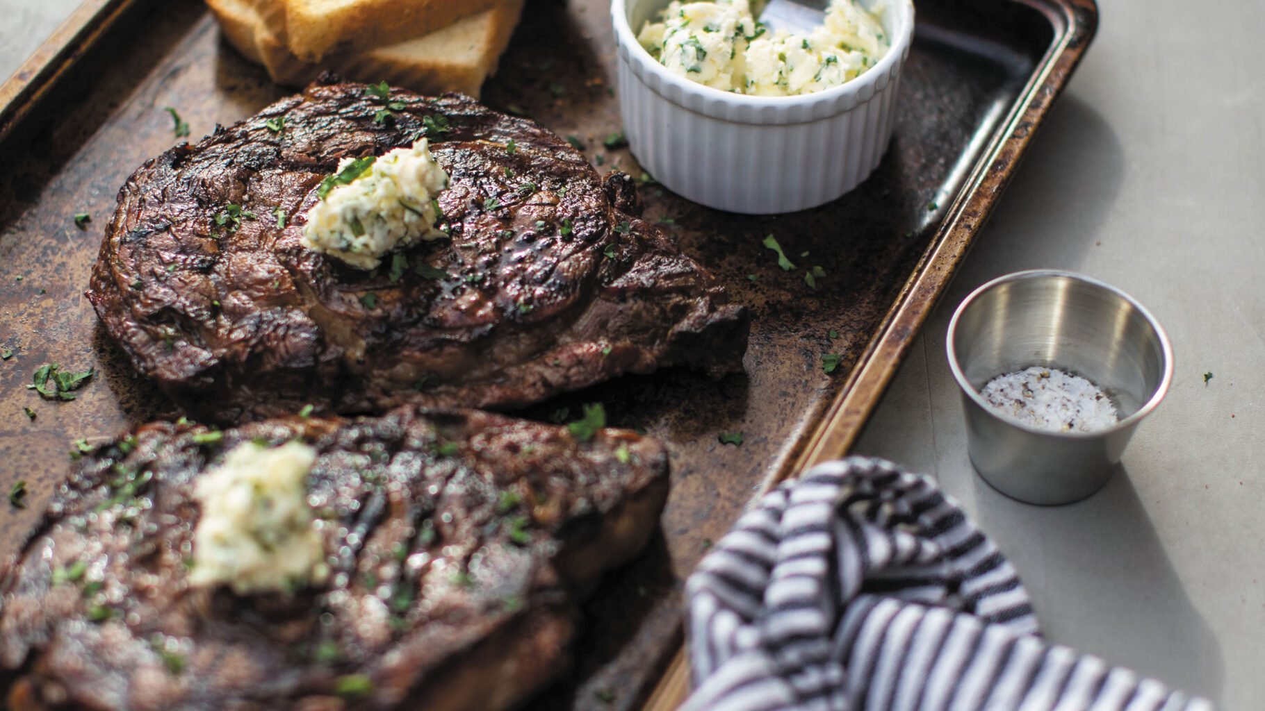 Grilled rib eye steaks recipe excerpted from Butcher on the Block by Matt Moore. © Matt Moore 2023. Published by Harvest, an imprint of HarperCollins. Photos © Andrea Behrends.