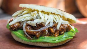 Smoked Pulled Pork Arepa excerpted from Arepa: Classic and Contemporary recipes for Venezuela’s Daily Bread by Irena Stein.