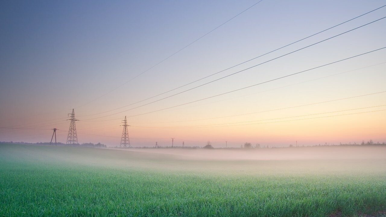power-lines-on-field-in-morning-fog-SBI-300870330-sm-e1710350997254
